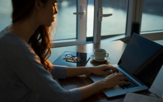 Woman working at a table with a laptop